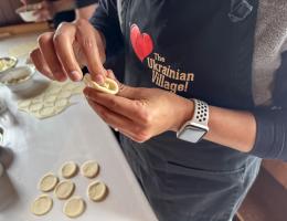 Two hands pinching dough to make a Ukrainian dumpling or perogy